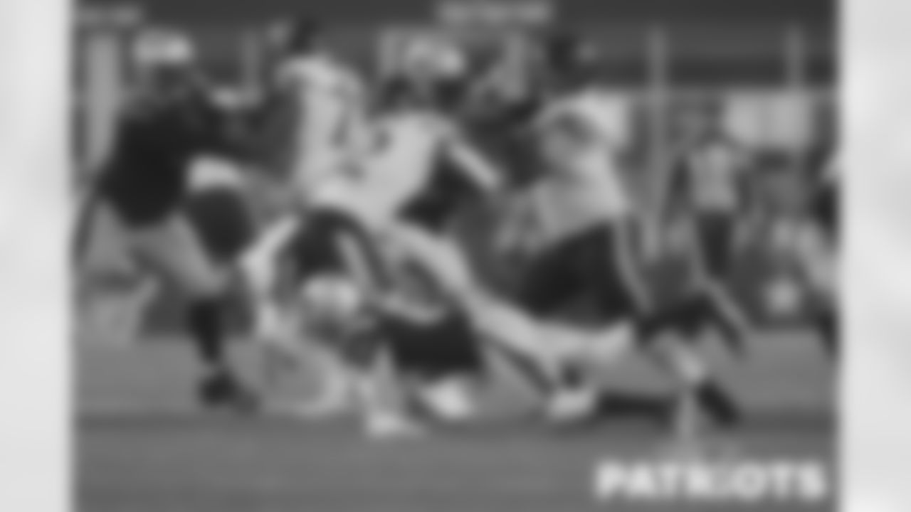 DB Jack Jones tackling RB David Montgomery in the backfield