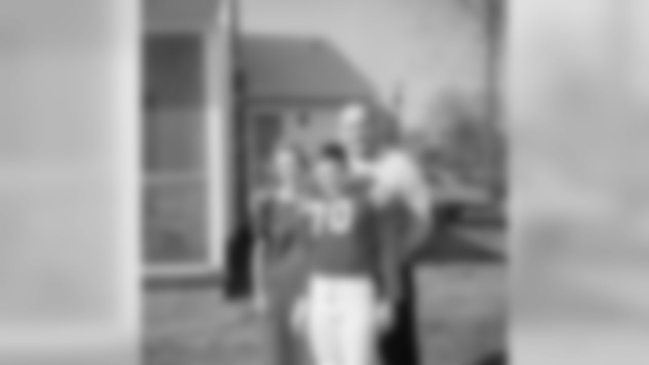 Bill Belichick in his junior high football uniform with his mom, Jeannette, and father, Steve.