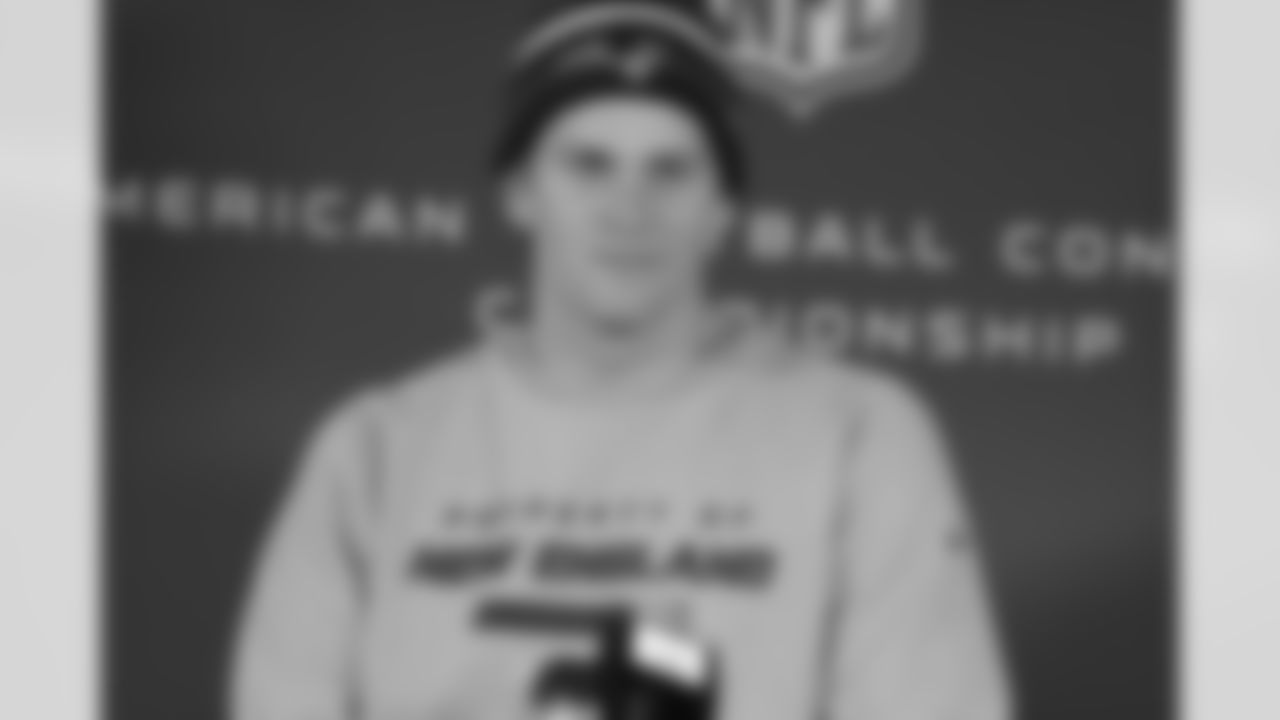 Tom Brady talks with the media