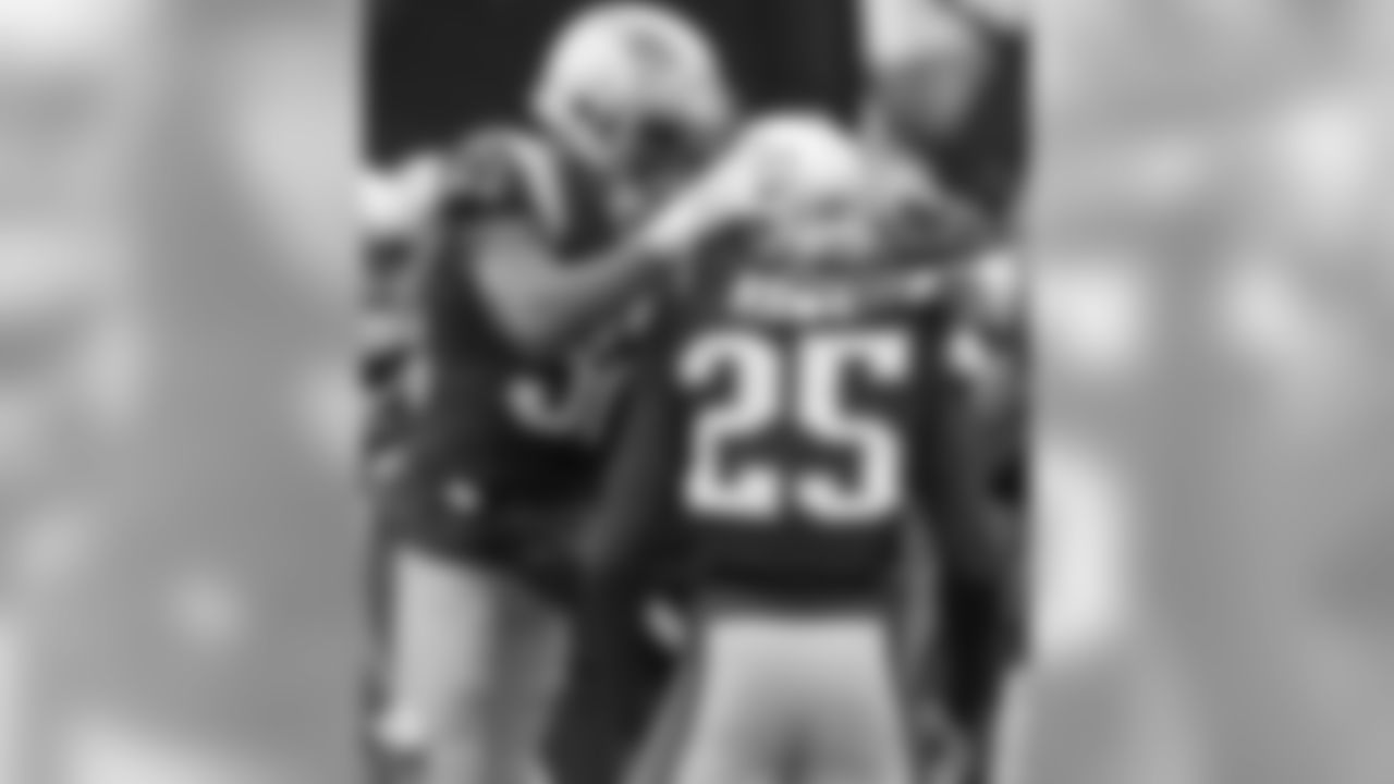 New England Patriots defensive back Devin McCourty (32) celebrates an interception by Eric Rowe (25) during the first half of an NFL football game against the New York Jets, Saturday, Dec. 24, 2016, in Foxborough, Mass. (AP Photo/Elise Amendola)