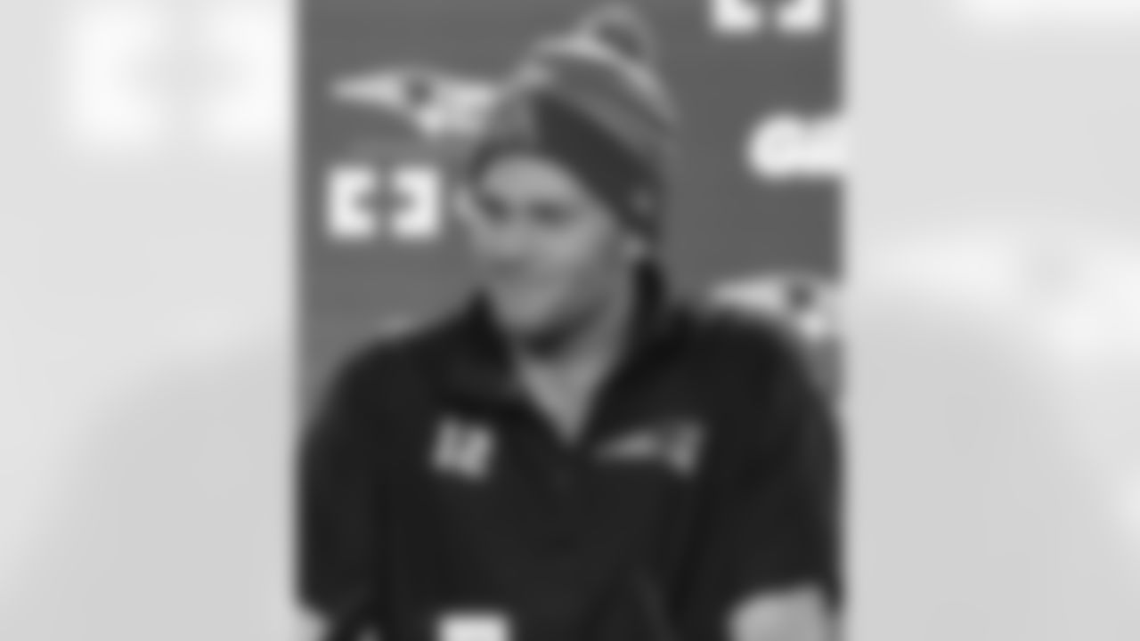 Tom Brady talks with the media