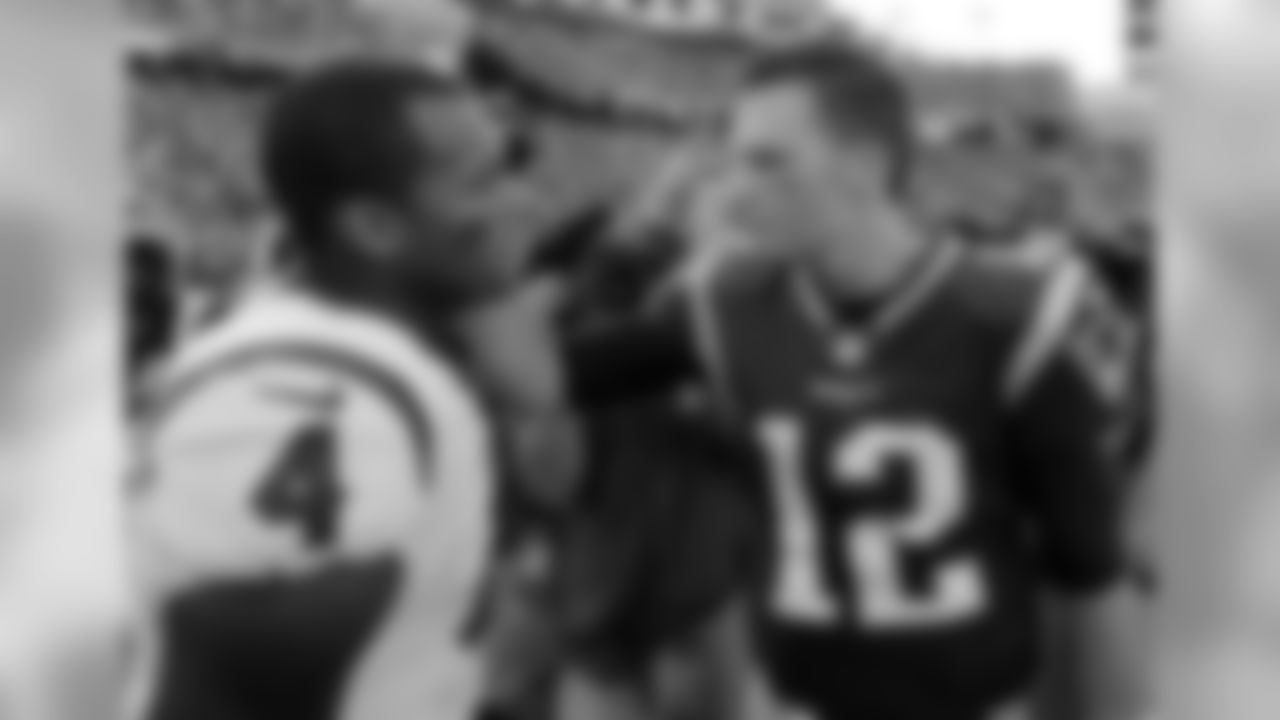 Houston Texans quarterback Deshaun Watson, left, and New England Patriots quarterback Tom Brady speak at midfield after an NFL football game, Sunday, Sept. 24, 2017, in Foxborough, Mass. (AP Photo/Steven Senne)