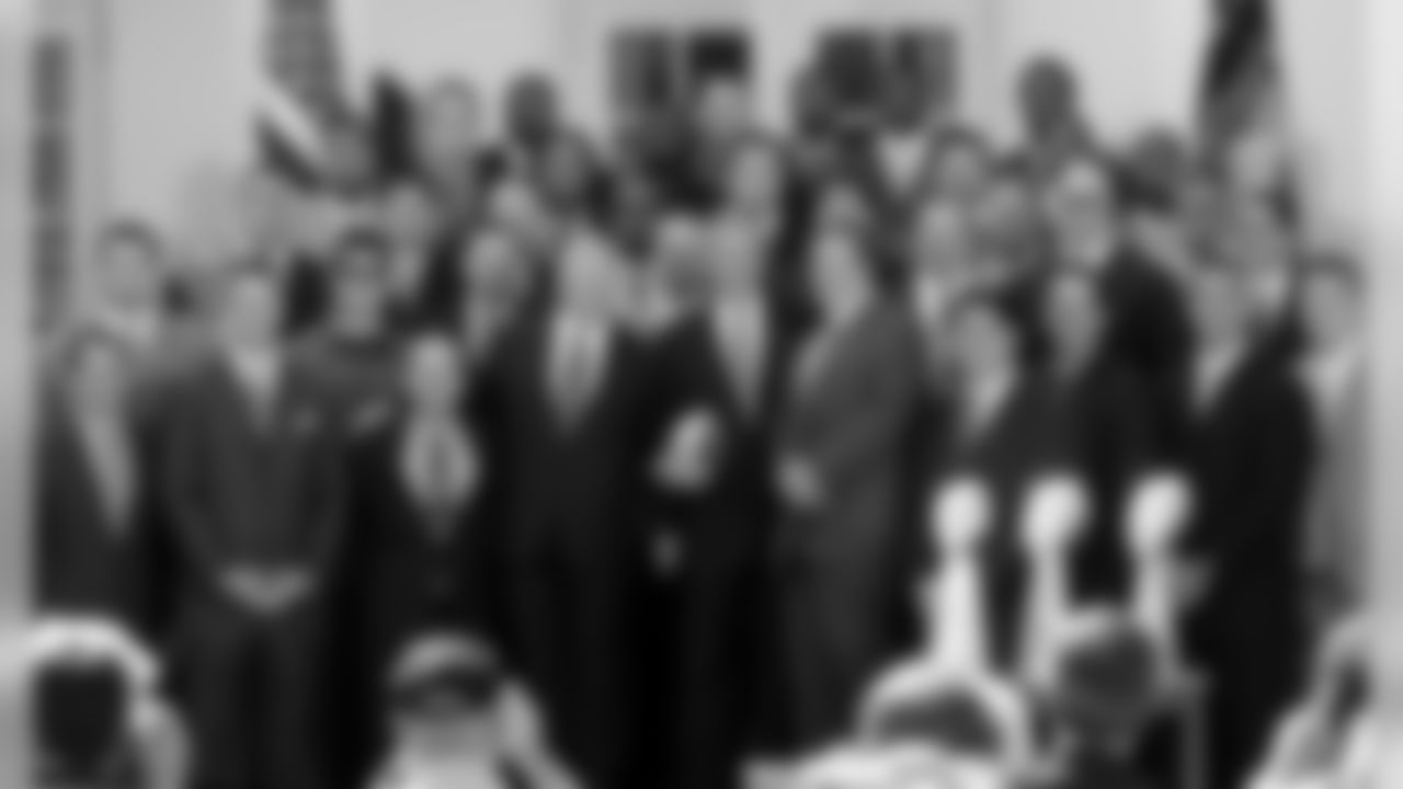 President Bush poses for a photo, flanked by New England Patriots owner Robert Kraft, left, Patriots coach Bill Belichick, right, and linebacker Teddy Bruschi, second from Bush's right, during a ceremony in the Rose Garden of the White House, Wednesday, April 13, 2005. (AP Photo/Susan Walsh)