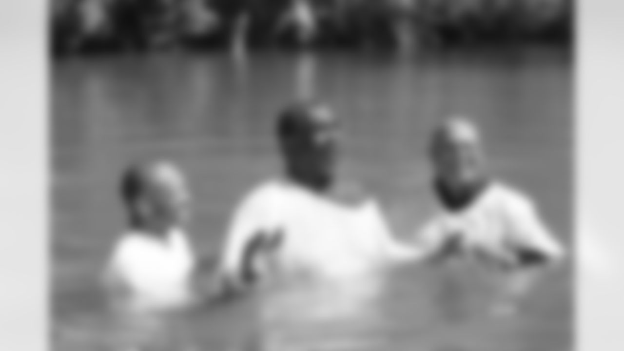 Mean Joe Green reacts after being baptized in the Jordan River.