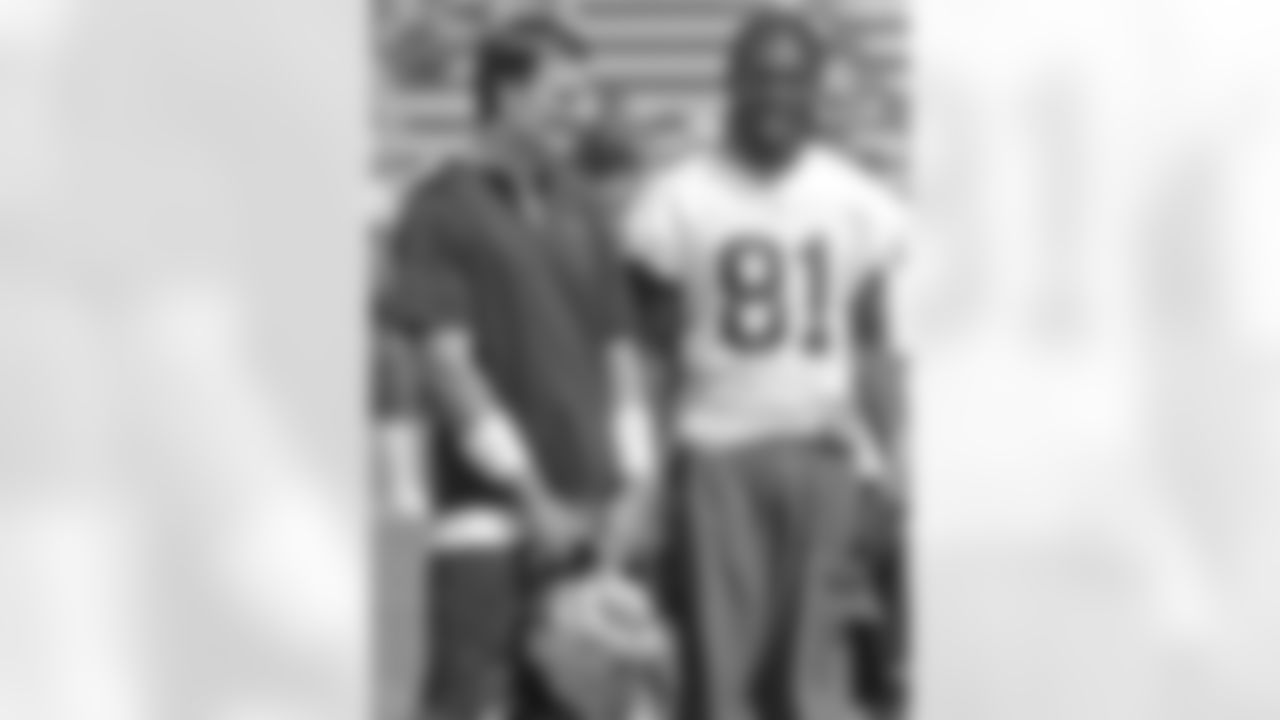 New England Patriots quarterback Tom Brady, left, and wide receiver Randy Moss (81) talk during a break in their practice session at the NFL Football team's training camp in Foxborough, Mass., Friday morning, Aug. 3, 2007. Photo by Stephan Savoia