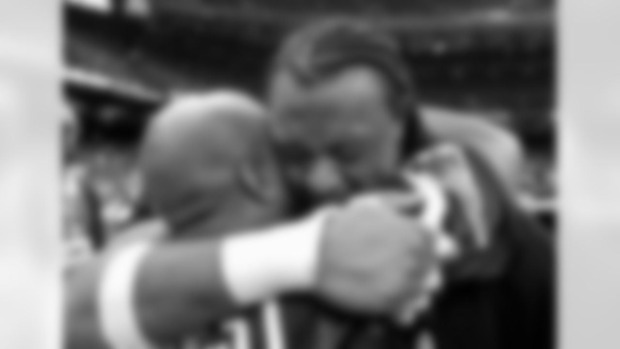 New England Patriots linebacker Willie McGinest, right, hugs a friend, Darrell Edwards, after the Patriots beat the St. Louis Rams 20-17 inSuper Bowl XXXVI Sunday, Feb. 3, 2002, in New Orleans. (AP Photo/David J. Phillip)