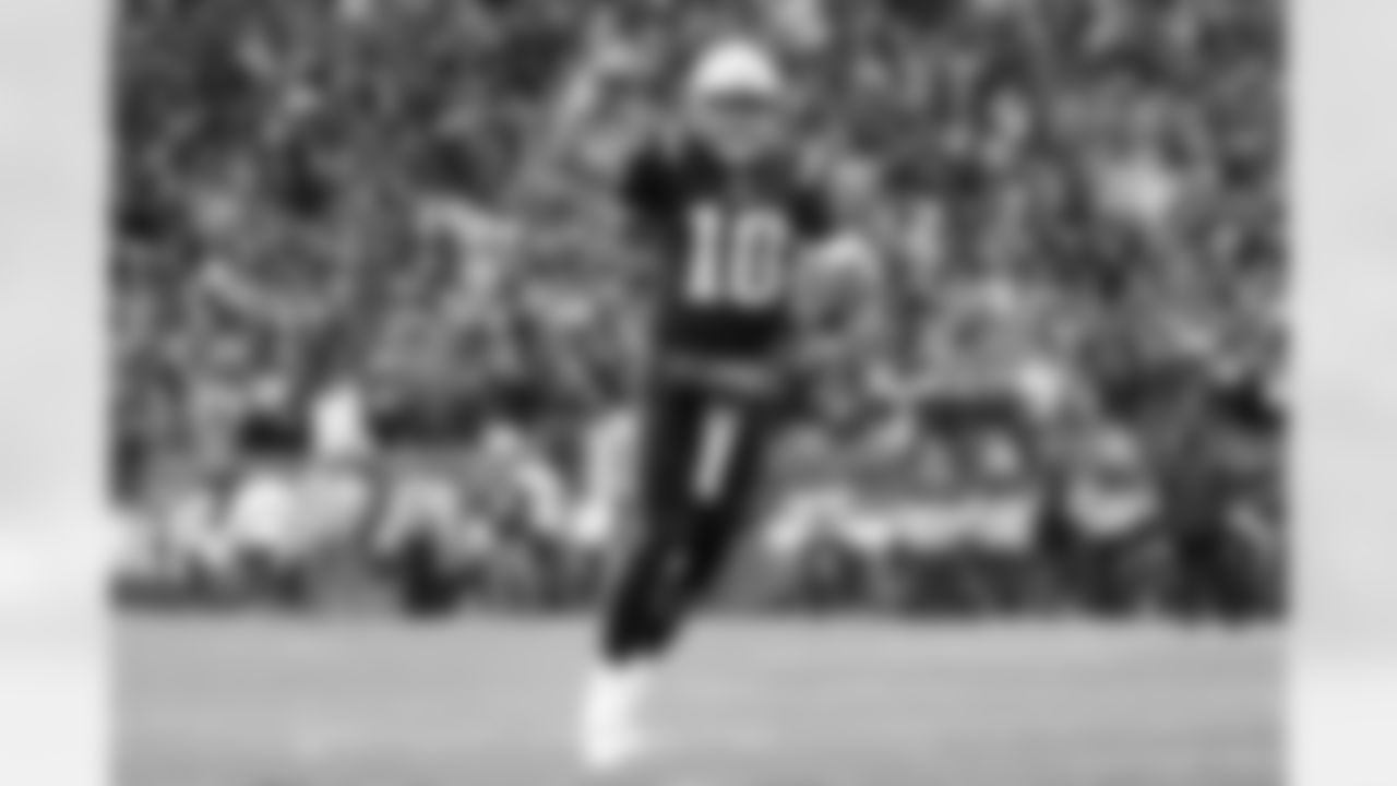 New England Patriots quarterback Mac Jones celebrates after a touchdown run by running back Damien Harris during the second half of an NFL football game against the Buffalo Bills, Sunday, Dec. 26, 2021, in Foxborough, Mass.