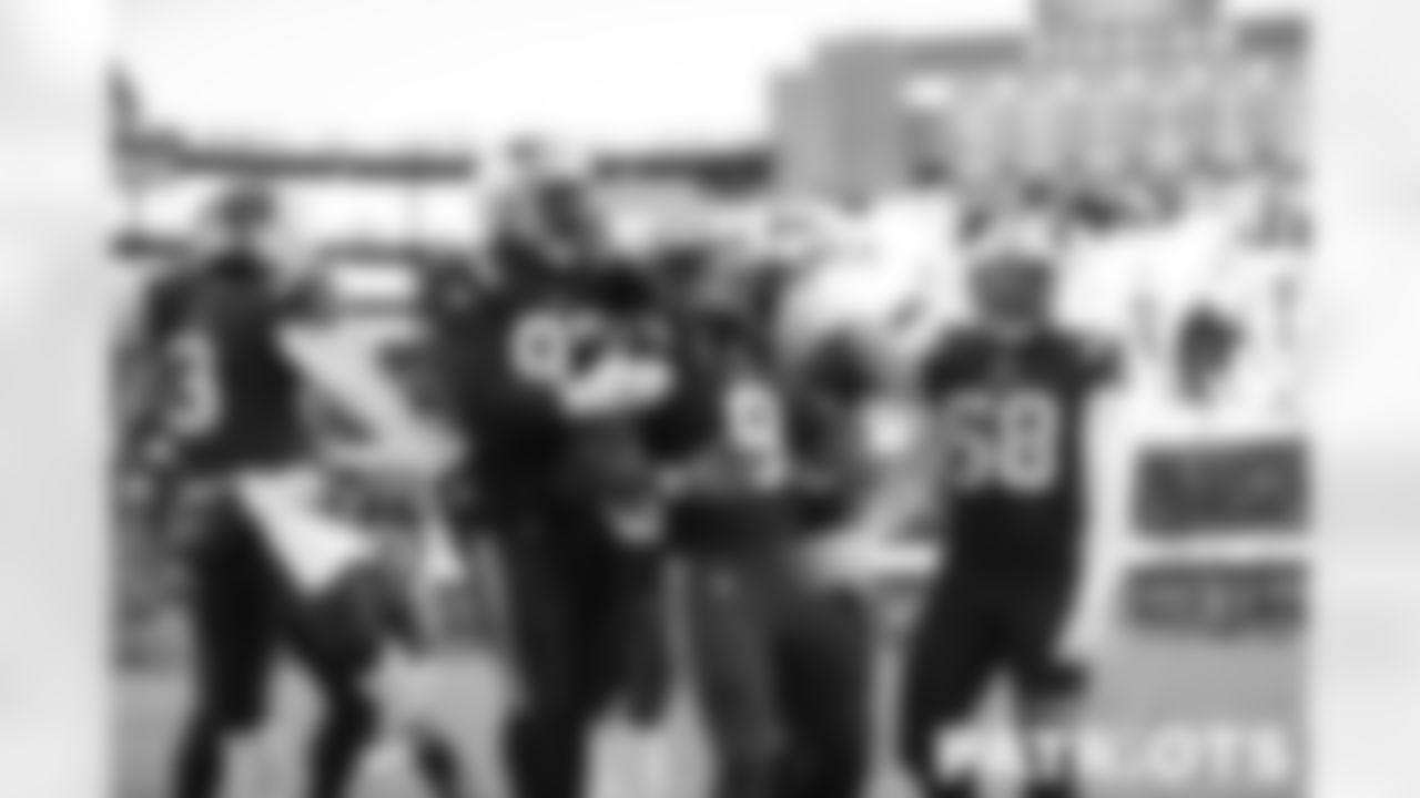 The Patriots defense celebrates a fumble recovery.