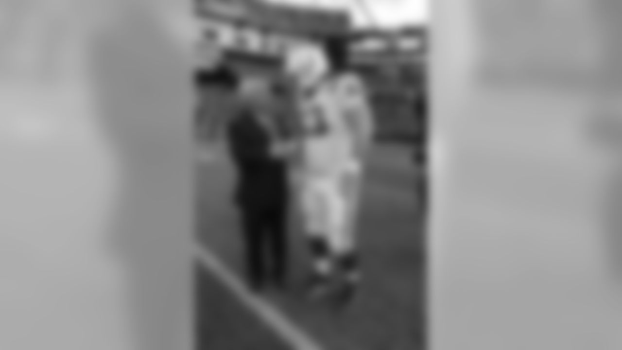 Patriots Chairman and CEO Robert Kraft talks with Colts C Jeff Saturday.