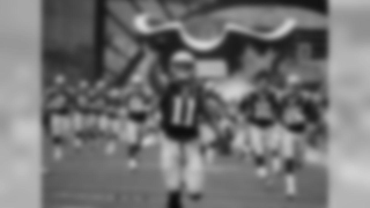 New England Patriots wide receiver Julian Edelman (11) leads teammates across the field prior to an NFL football game against the Oakland Raiders Sunday, Sept. 21, 2014, in Foxborough, Mass. (AP Photo/Elise Amendola)