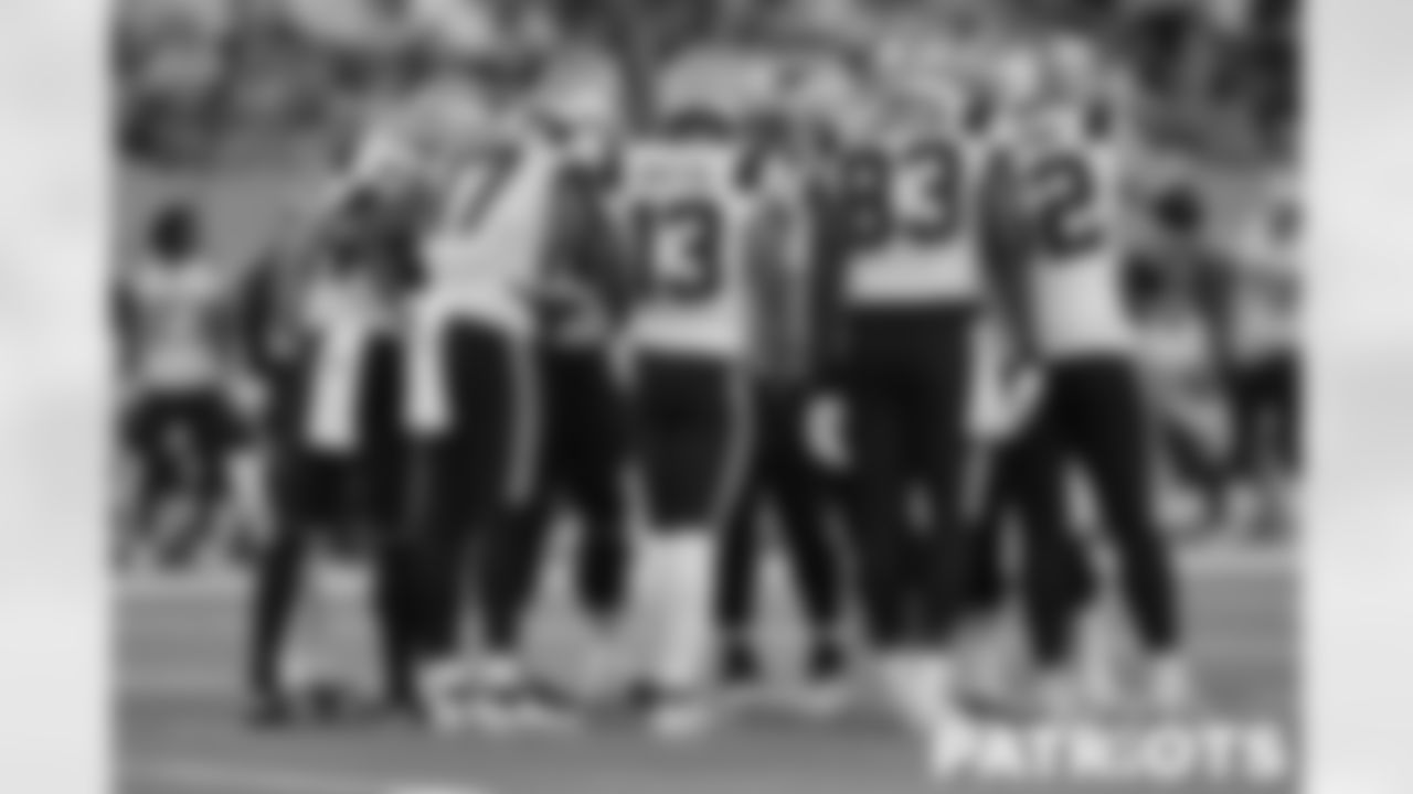 Patriots offense huddles during the third quarter.