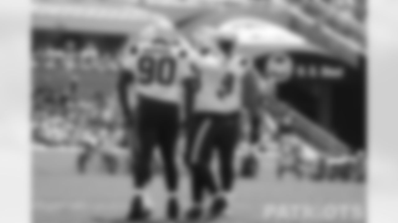 Patriots defense celebrates a sack