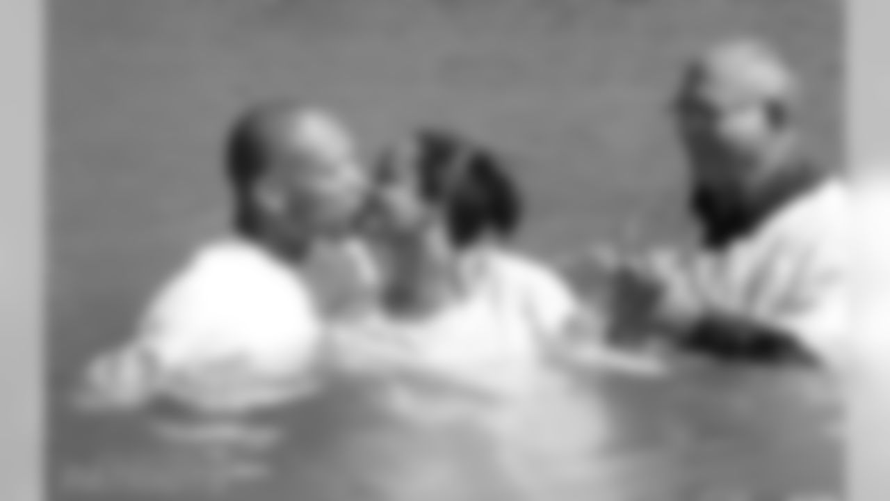 Tracy Williams and her husband, Aeneas, embrace after she was baptized in the Jordan River.