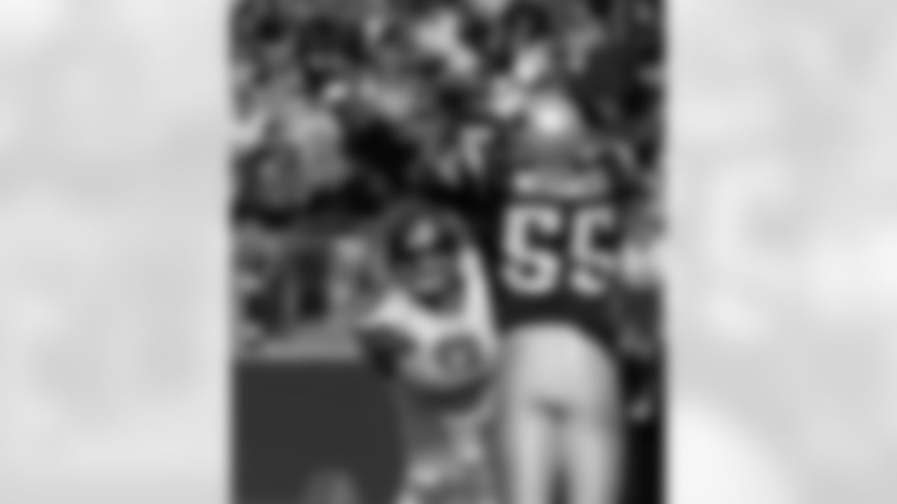 Seattle Seahawks quarterback Matt Hasselbeck (8) passes around the out stretched arms of New England Patriots linebacker Willie McGinest (55) during second quarter action of their NFL game Sunday afternoon Oct. 17, 2004 in Foxboro Mass. (AP Photo/Stephan Savoia)