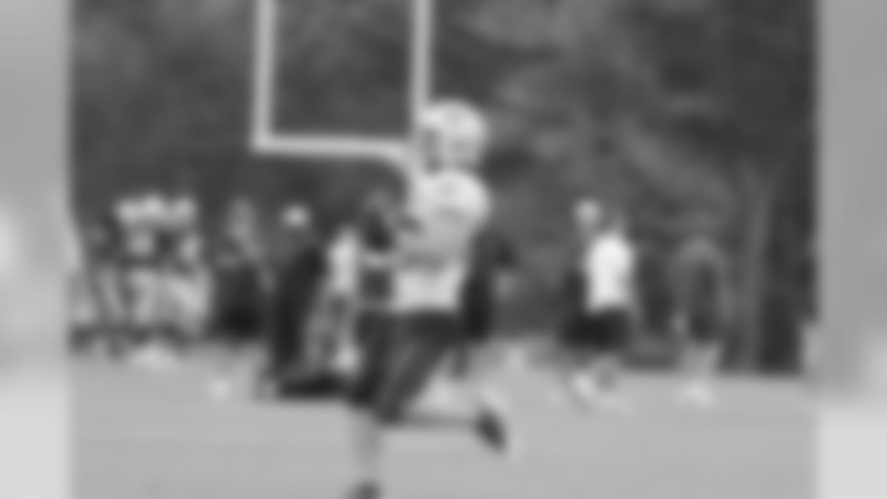 Wes Welker runs through a drill during training camp