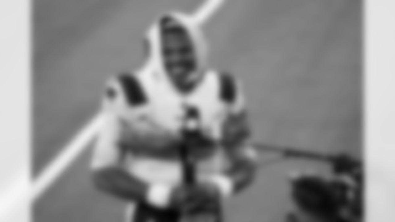 New England Patriots quarterback Cam Newton smiles as he conducts an interview at the end of an NFL football game against the Los Angeles Chargers Sunday, Dec. 6, 2020, in Inglewood, Calif. (AP Photo/Ashley Landis)