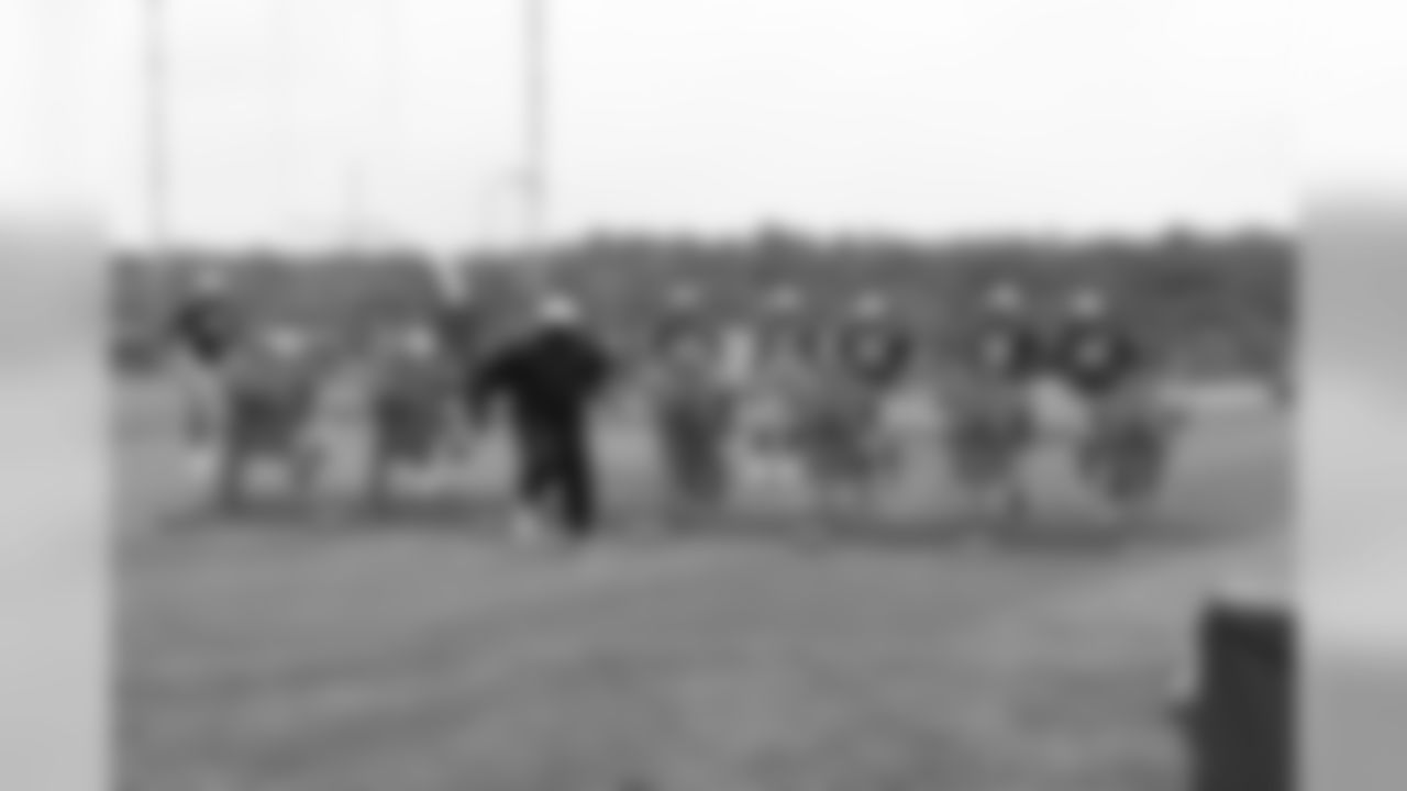 The defensive line runs through training camp drills