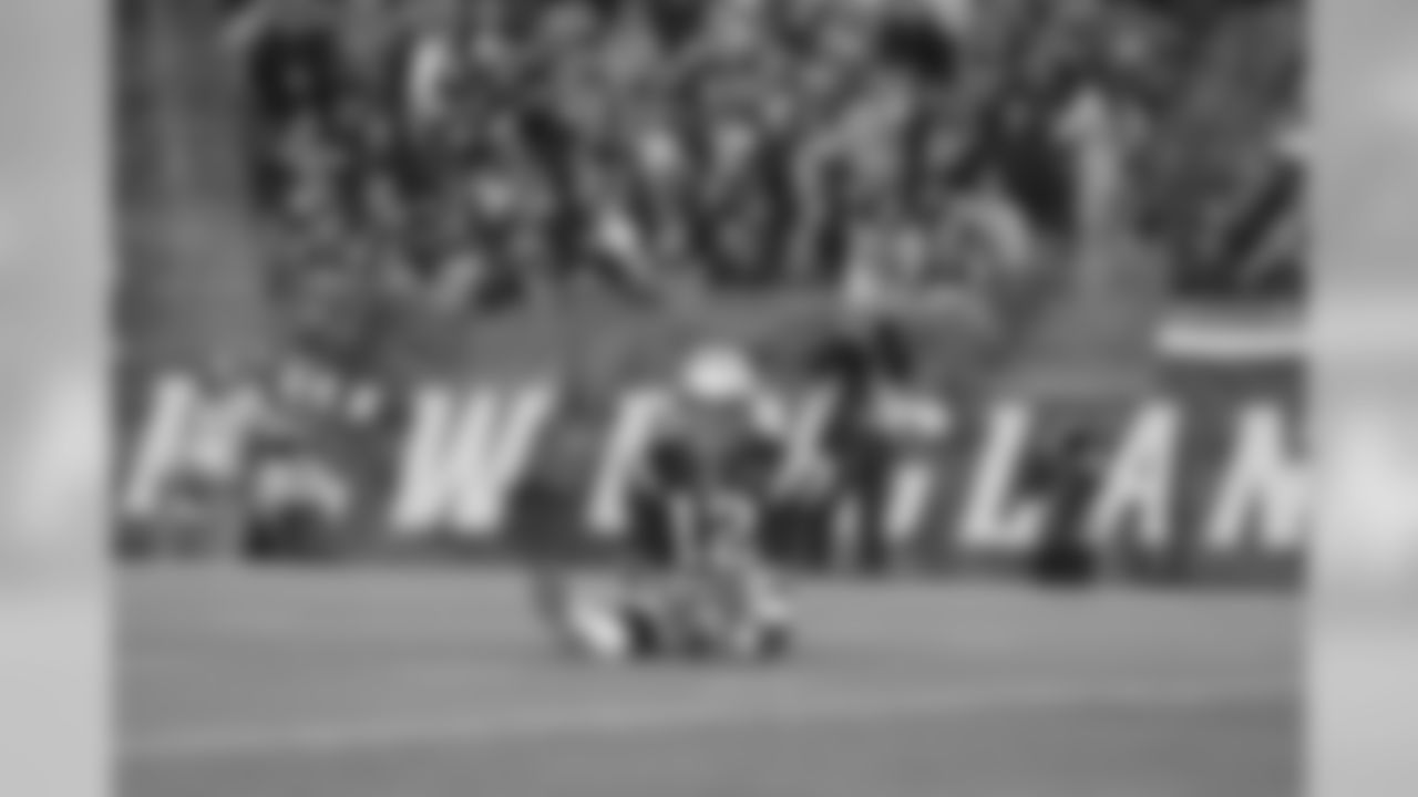 Patriots QB Tom Brady quickly returns to his feet after being brought to the ground.