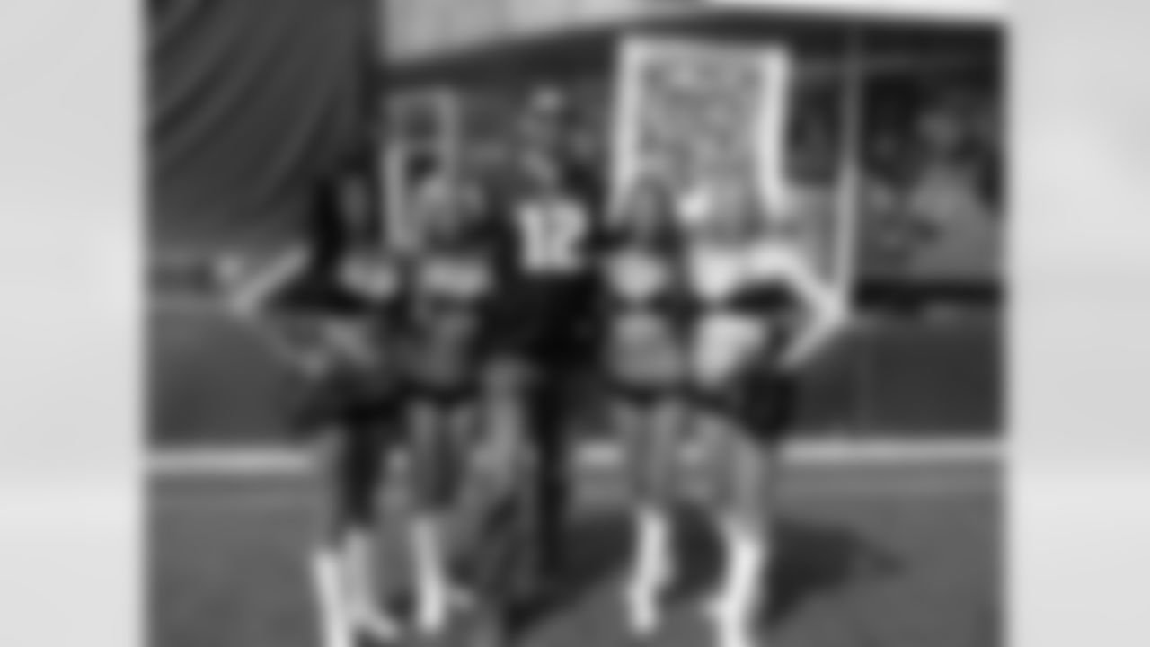 The cheerleaders with a Patriots fan.