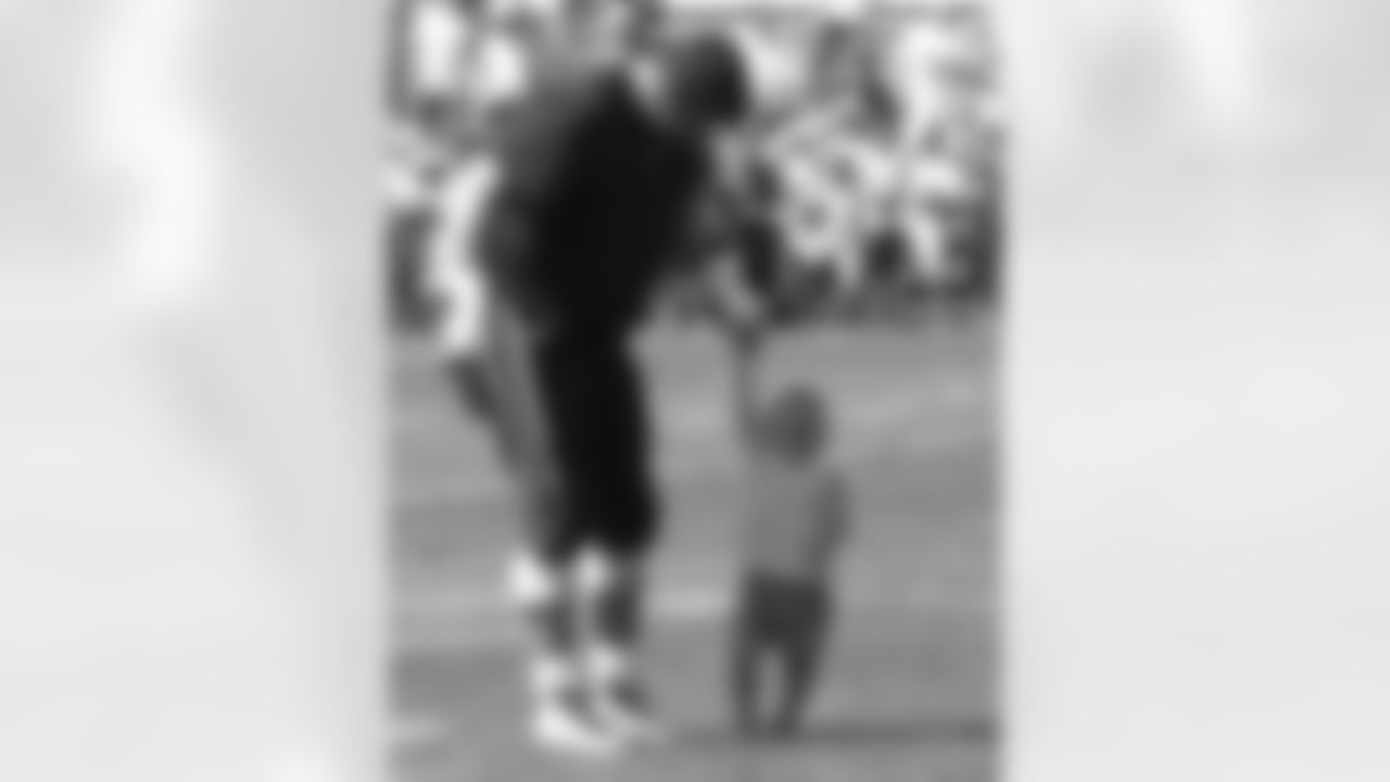 Guard Stephen Neal(61) plays with his daughter on the field after morning practice ends on Day 2 of Training Camp. 7/29/2006 Photo by Elizabeth Propper