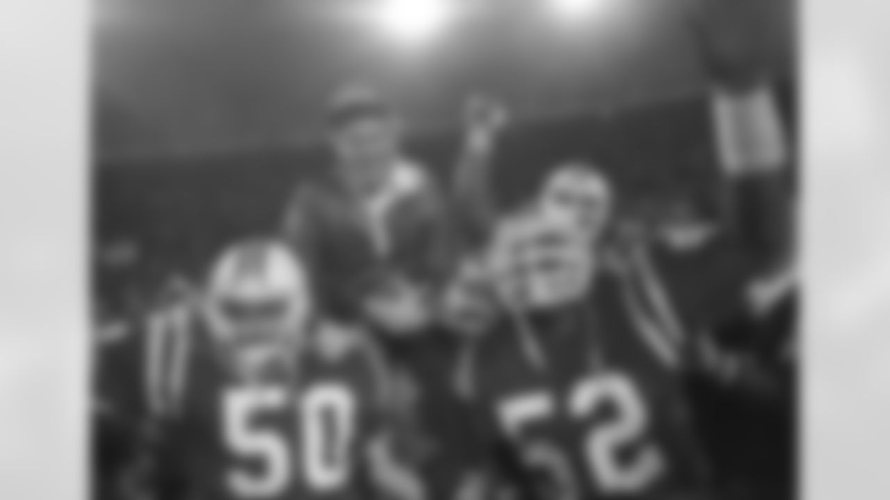 FILE - IN this Jan. 12, 1986, file photo, New England Patriots coach Raymond Berry gets a victory ride from players Larry McGrew (50) and Johnny Rembert (52) after the Patriots defeated the Miami Dolphins 31-14 in the NFL football AFC playoffs in Miami. The football that Johnny Unitas threw to Raymond Berry for a touchdown in the historic 1958 NFL Championship game is being sold at auction. The ball has an estimated value of $40,000-$70,000. (AP Photo/File)