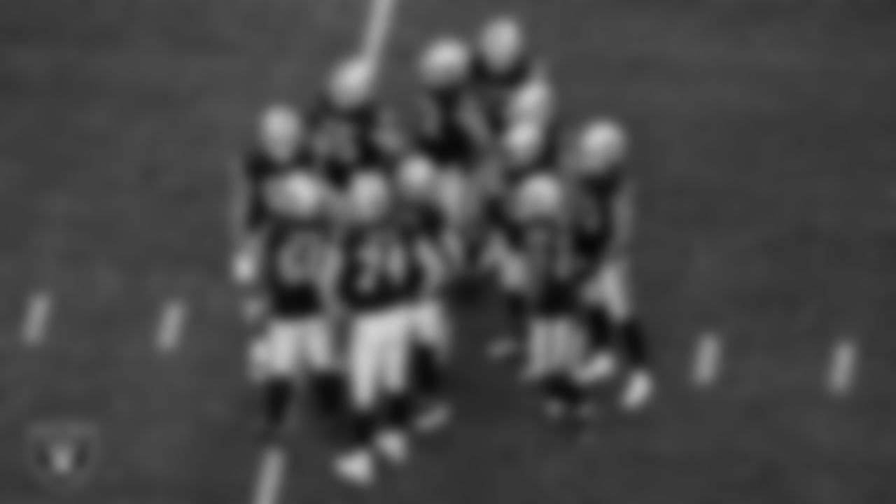 The Las Vegas Raiders offense huddle during the regular season home game against the New England Patriots at Allegiant Stadium.