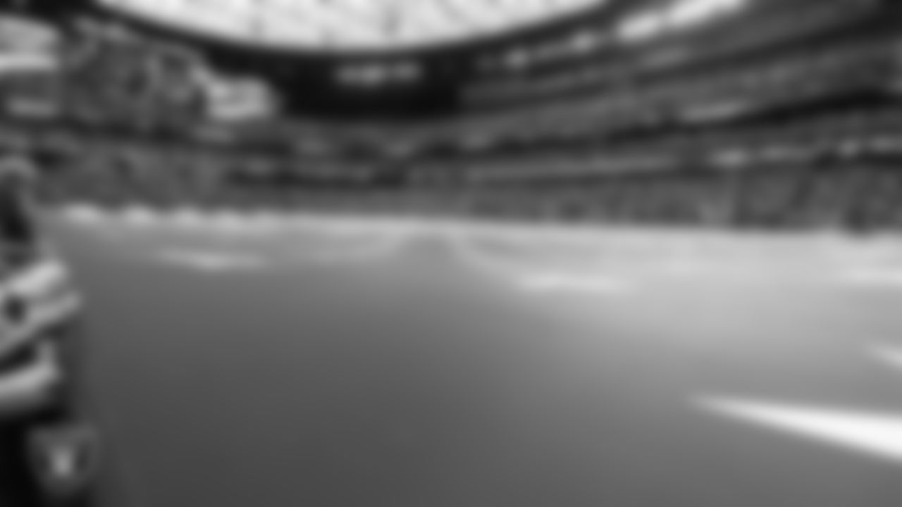 The American flag is displayed by Personal Seat License (PSL) holders on the field during the national anthem before the Las Vegas Raiders' regular season home game against the Arizona Cardinals at Allegiant Stadium.