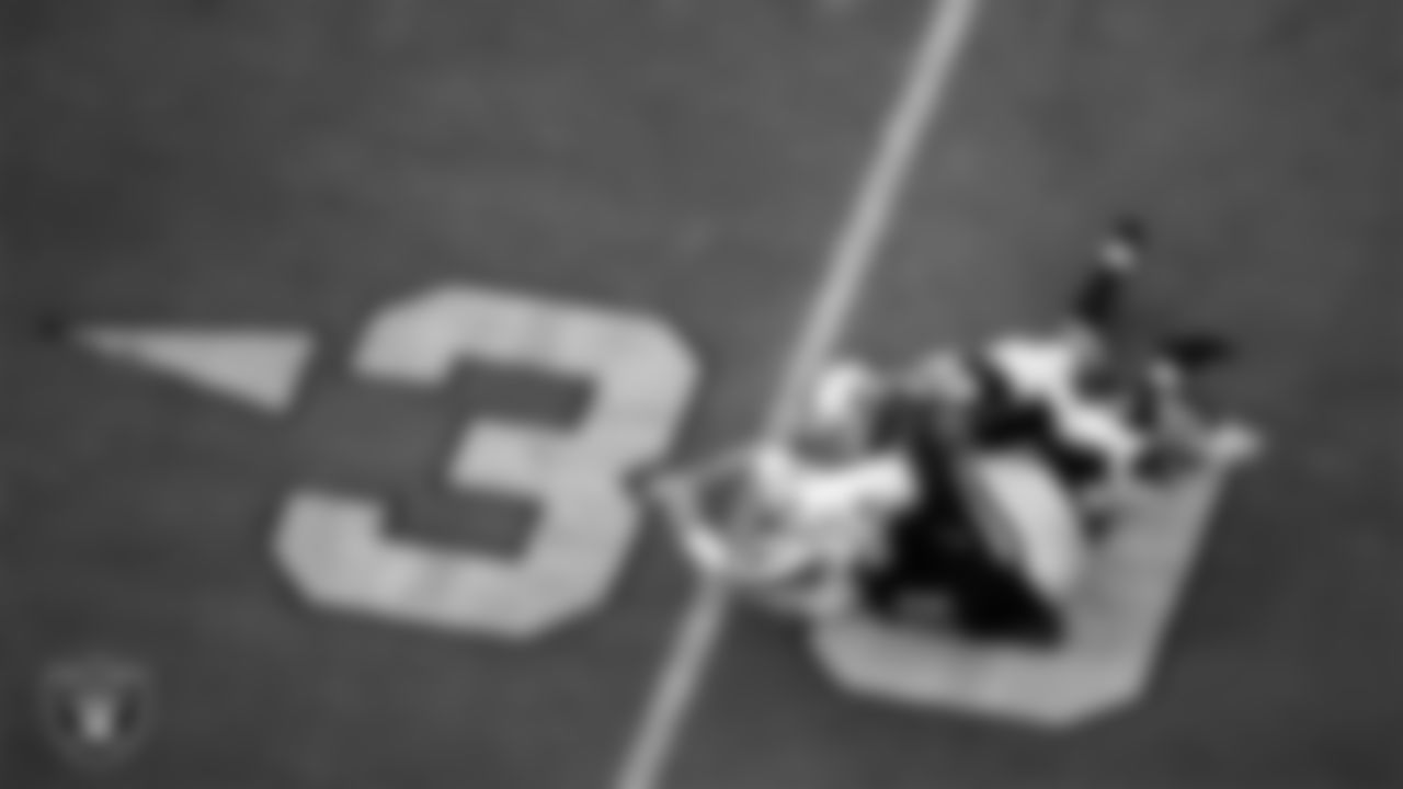 Las Vegas Raiders defensive end Arden Key (99) and cornerback Keisean Nixon (22) knock down the quarterback during the regular season home game against the Buffalo Bills.