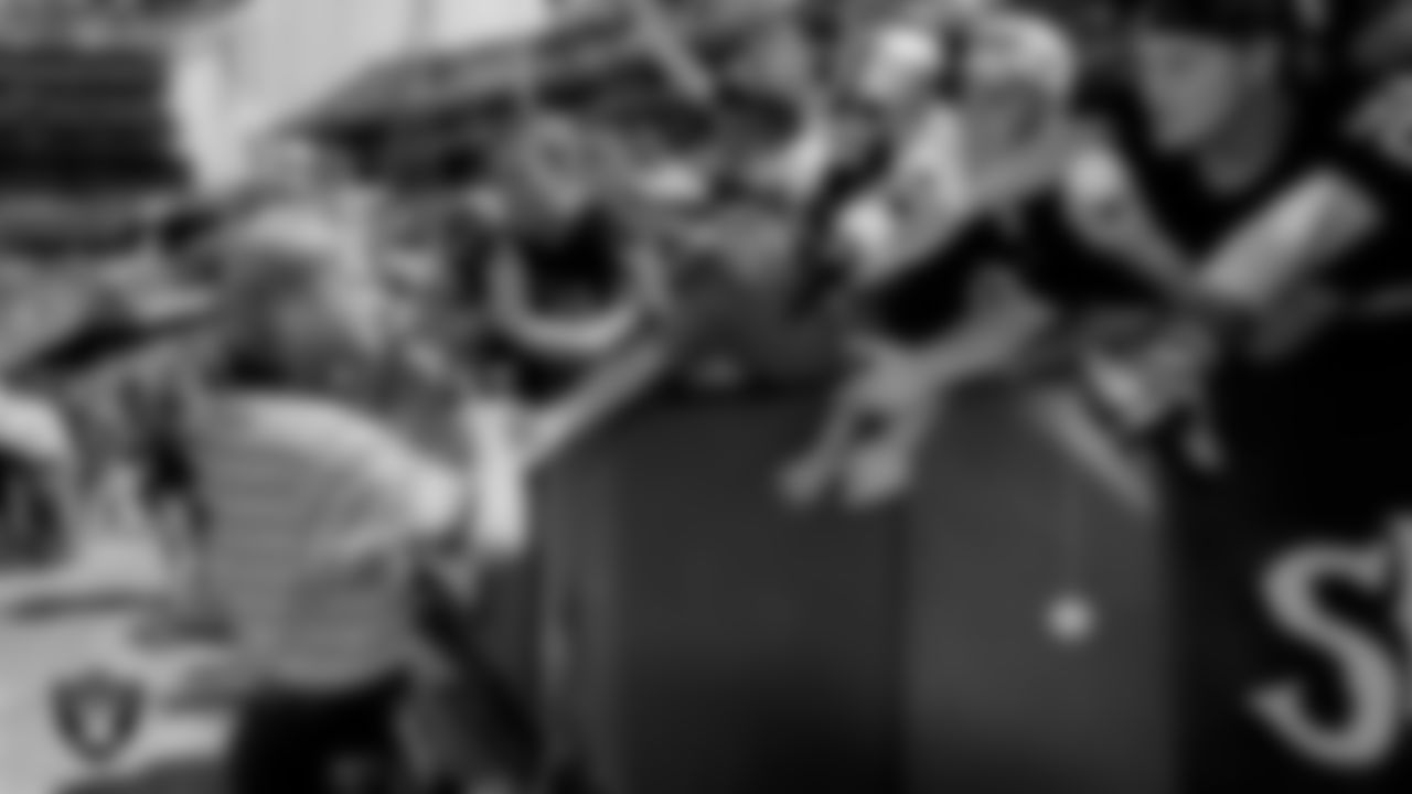 Raiders Head Coach Jon Gruden with fans before a game in 2000.