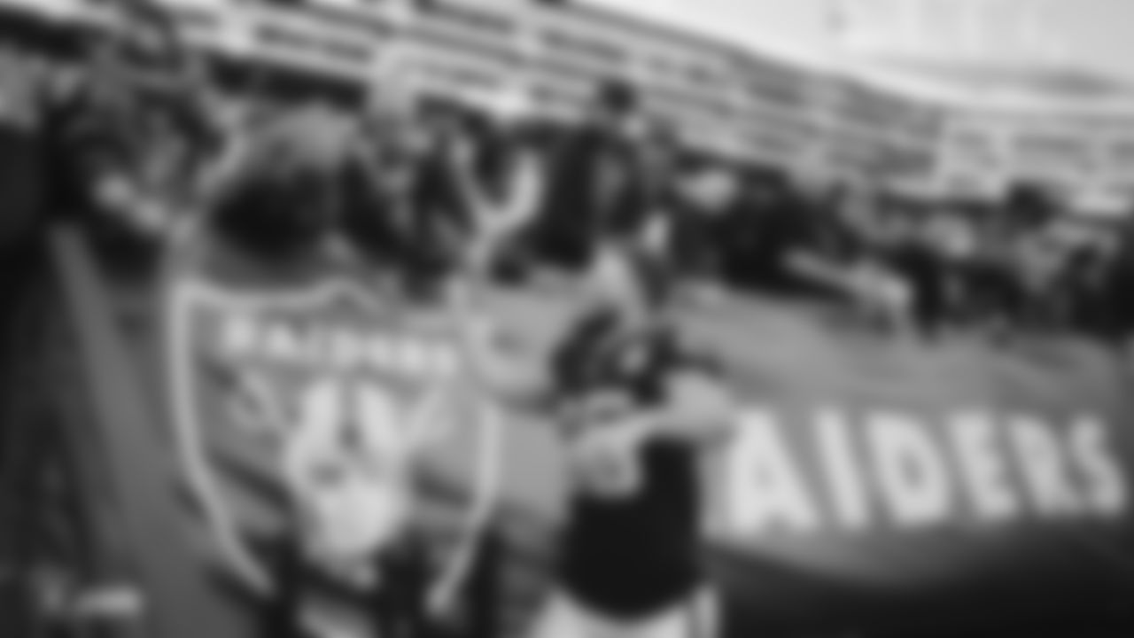 Raiders safety Erik Harris (25) high fives fans after the regular season game against the Jacksonville Jaguars.