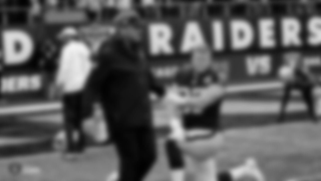 Raiders Head Coach Jon Gruden high fives defensive end Josh Mauro (97) during warm ups before the regular season game against the Chicago Bears at Tottenham Hotspur Stadium.