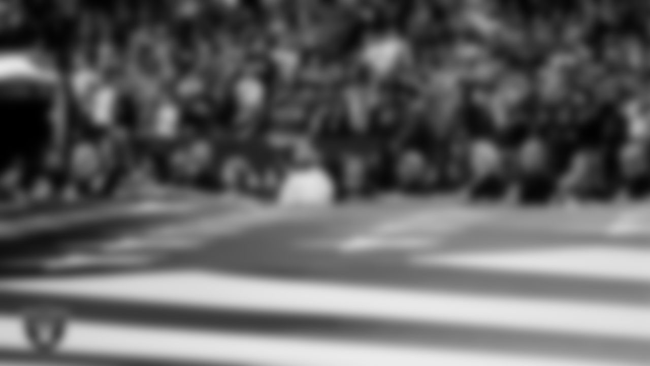 The American flag is displayed by Personal Seat License (PSL) holders on the field during the national anthem before the Las Vegas Raiders regular season home game against the Kansas City Chiefs.