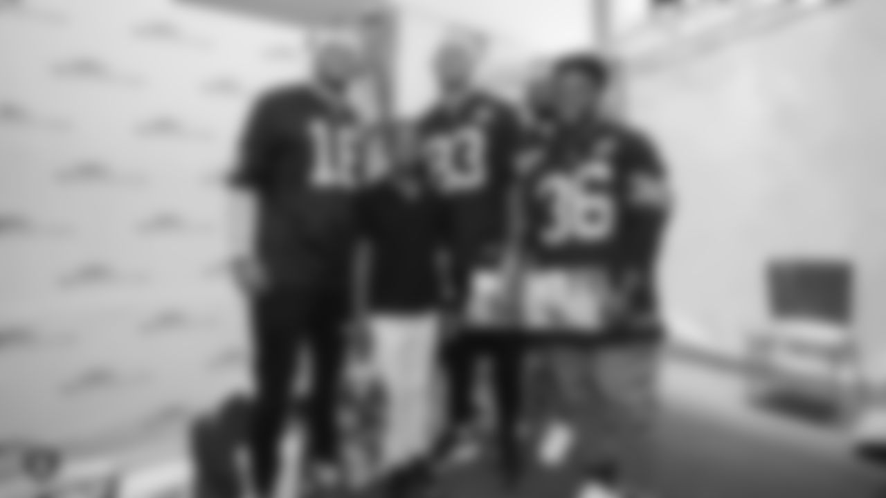 Raiders defensive tackle Maurice Hurst (73), tight end Darren Waller (83), wide receiver Tyrell Williams (16) and running back James Butler (36) pose for a picture with a kid during a visit to UCSF Benioff Children's Hospital Oakland.