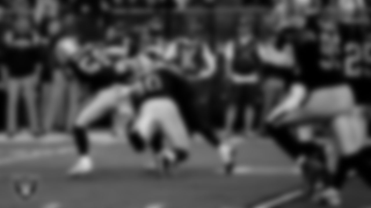 Las Vegas Raiders linebacker Luke Masterson (59) and defensive lineman Jerry Tillery Jr. (90) make a tackle during the regular season home game against the New England Patriots at Allegiant Stadium.