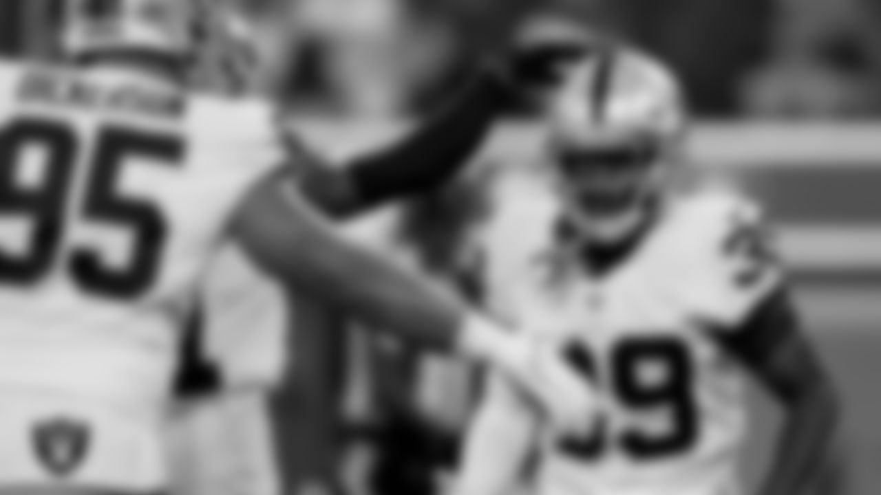 Las Vegas Raiders defensive tackle Matt Dickerson (95) and cornerback Nate Hobbs (39) during the preseason game against the Los Angeles Rams at SoFi Stadium.