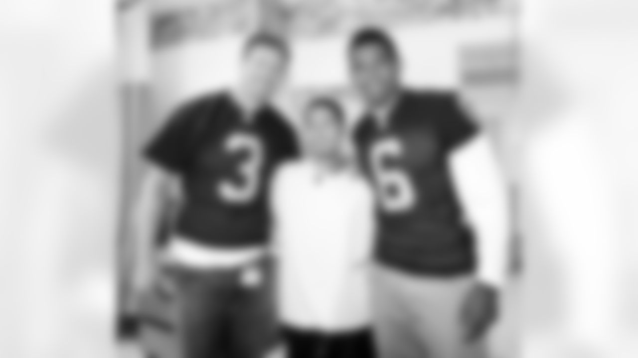 QBs Carson Palmer and Terrelle Pryor take a photo with die-hard Raiders fan Luis.