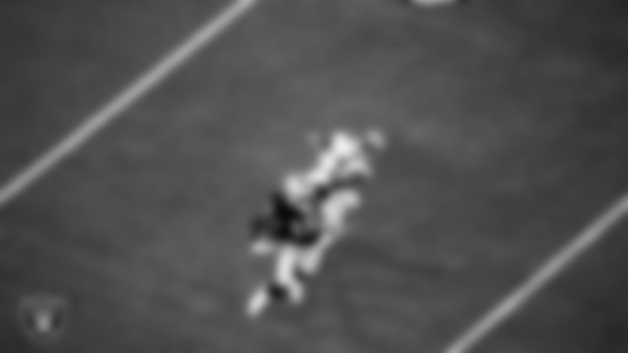 Las Vegas Raiders wide receiver Nelson Agholor (15) stiff arms the defender during the regular season home game against the New Orleans Saints.
