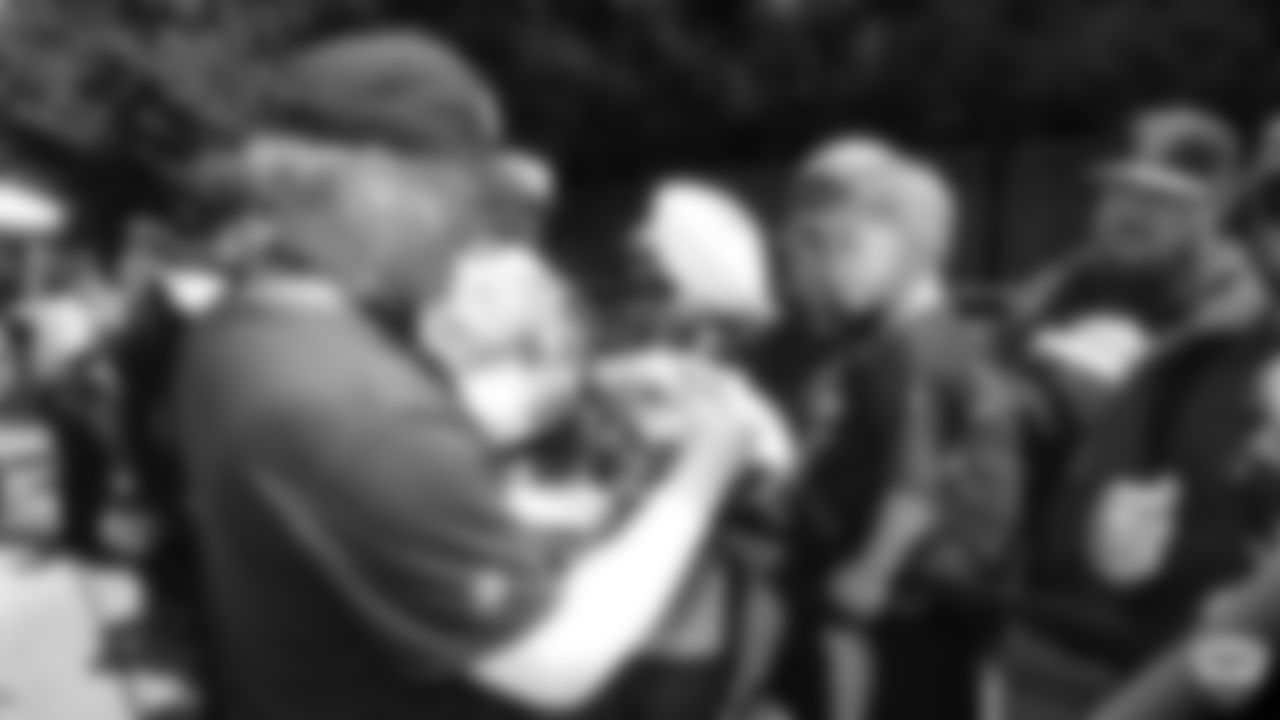 Raiders head coach Jon Gruden signs autographs for fans after practice at 2019 Training Camp.