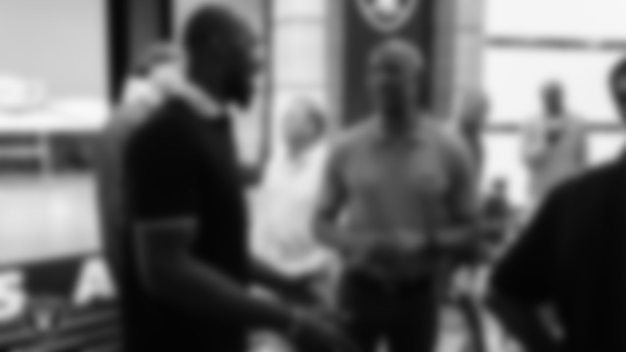 Las Vegas Raiders defensive end Chandler Jones (55) and alumnus James Lofton speak during an alumni dinner.