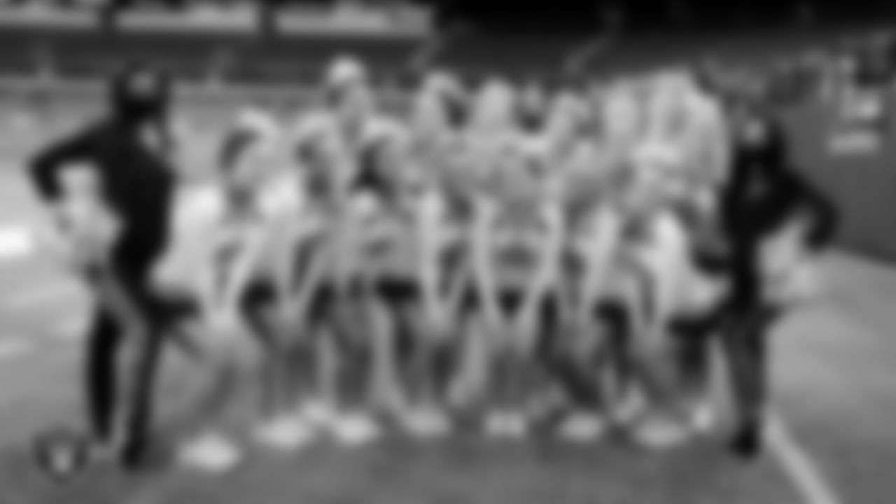 Raiderettes Gabby L. And Meghan pose for a photo with the Shadow Ridge High School cheerleading squad before a game against Silverado High School at the NIAA Class 4A State Football Championship at Allegiant Stadium.