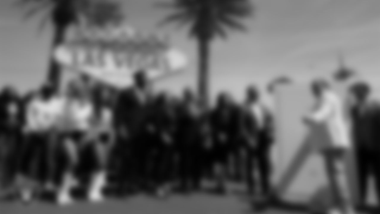 Las Vegas Raiders Owner Mark Davis flips the switch to turn the "Welcome to Fabulous Las Vegas" sign silver and black.