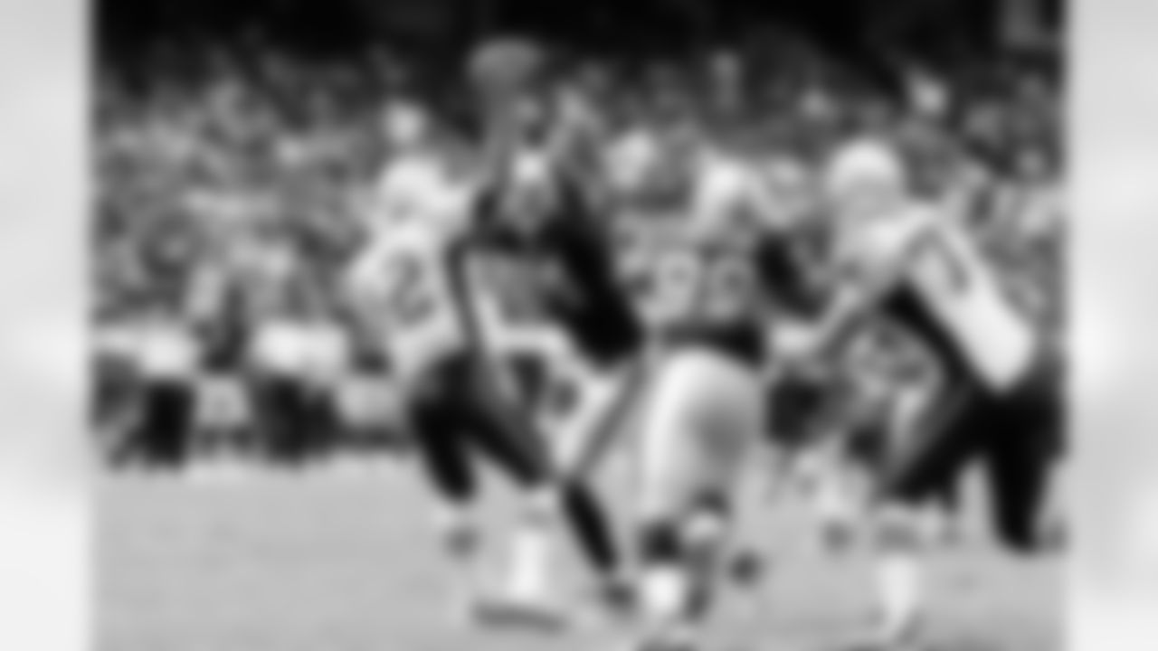 DE Jarvis Moss pressures Brady, causing him to overshoot his receiver.