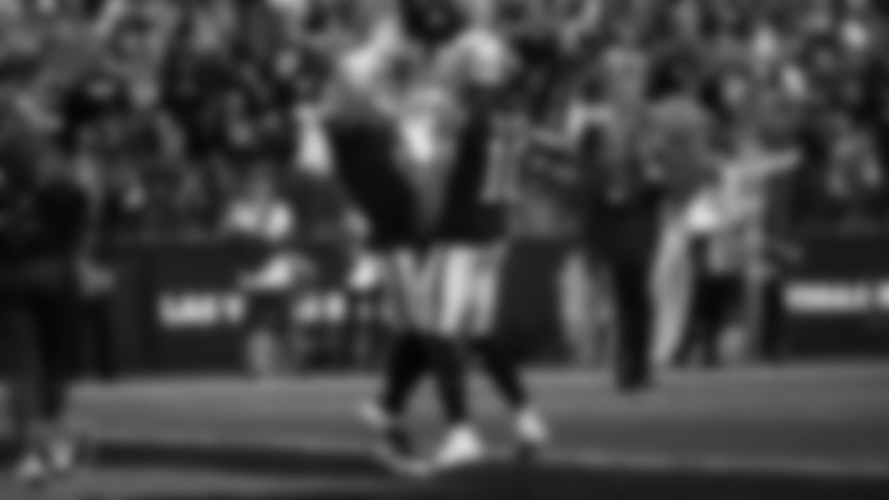 Las Vegas Raiders wide receiver Mack Hollins (10) celebrates with quarterback Derek Carr (4) after making a 5-yard touchdown catch during the regular season home game against the New England Patriots at Allegiant Stadium.