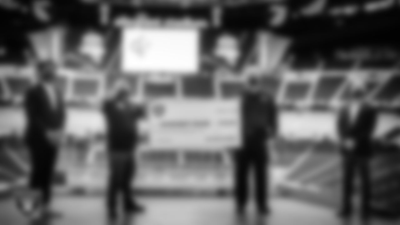 Las Vegas Raiders Senior Advisor Marcel Reece and President Marc Badain present a check to Michael Arroyo and Bob Brown from Opportunity Village.