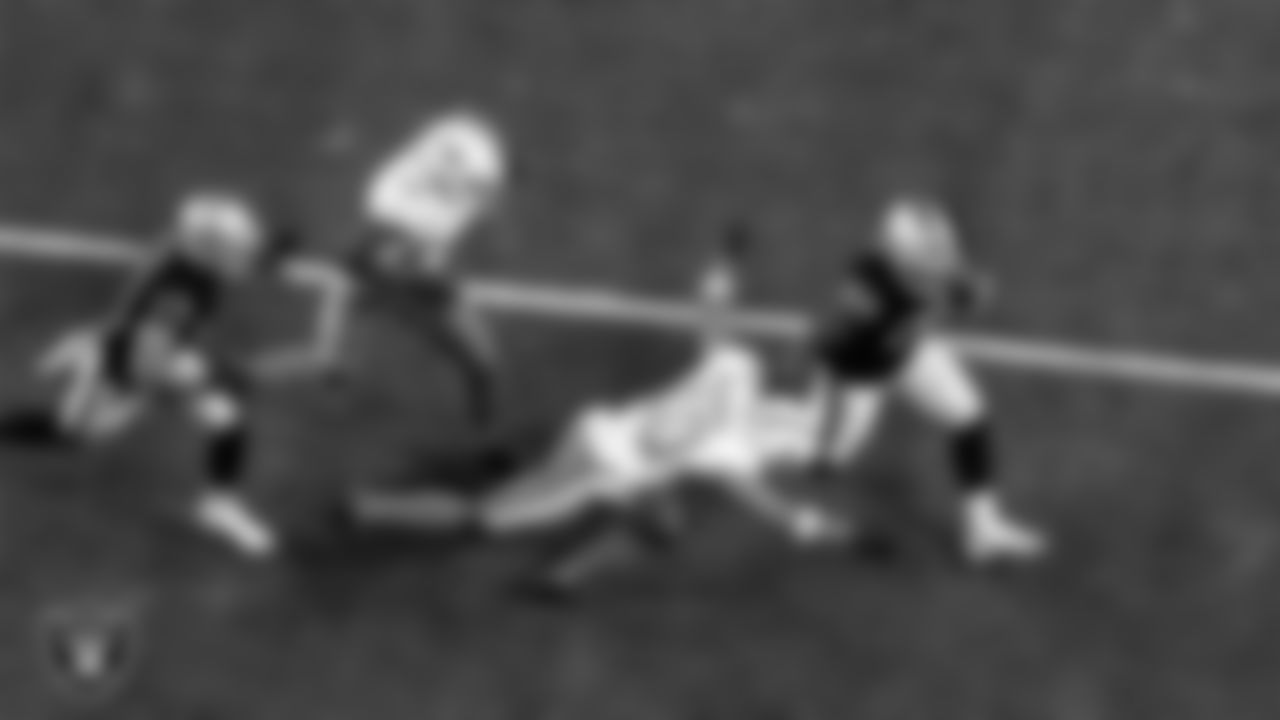 Las Vegas Raiders running back Josh Jacobs (28) stiff arms the defender during the regular season home game against the Miami Dolphins.