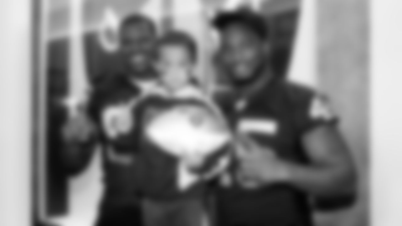 LB Kamerion Wimbley and FB Marcel Reece signed autographs for toys at the Southland Mall Raider Image store. Photo by Tony Gonzales.