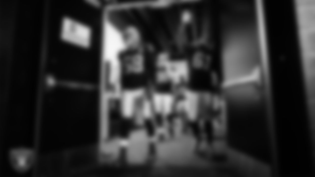 Las Vegas Raiders linebacker Kyle Wilber (58), defensive end Maxx Crosby (98), safety Lamarcus Joyner (29) and center Rodney Hudson (61) leave the locker room before the regular season home game against the Miami Dolphins.
