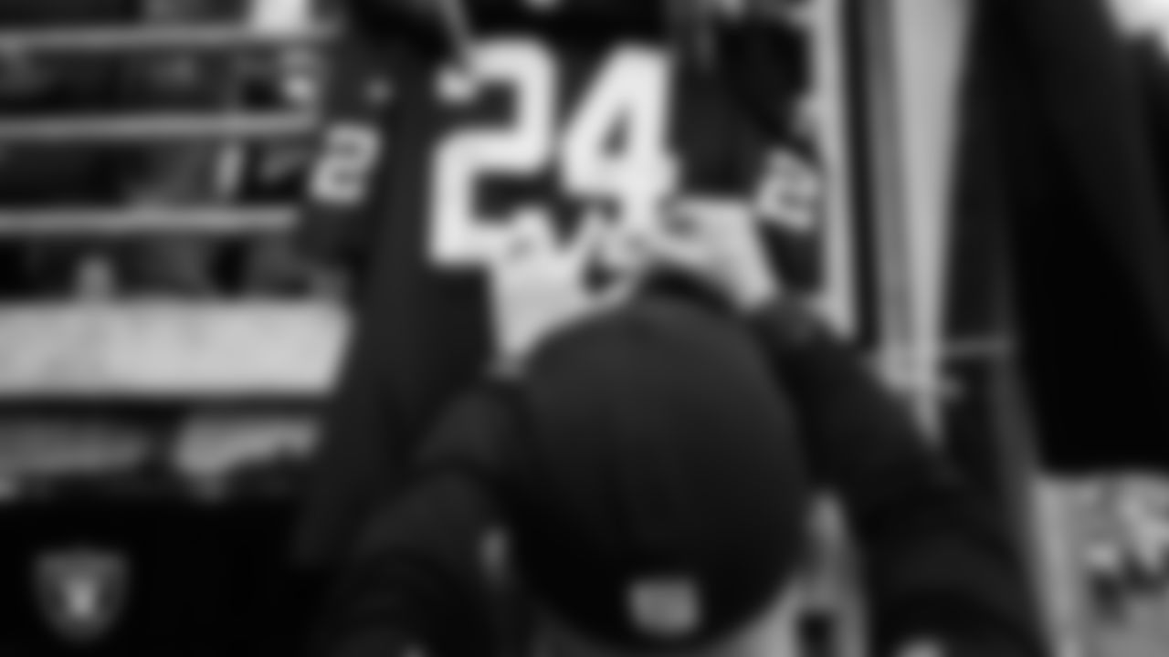 Las Vegas Raiders defensive coordinator Gus Bradley signs autographs for fans before the regular season away game against the New York Giants.