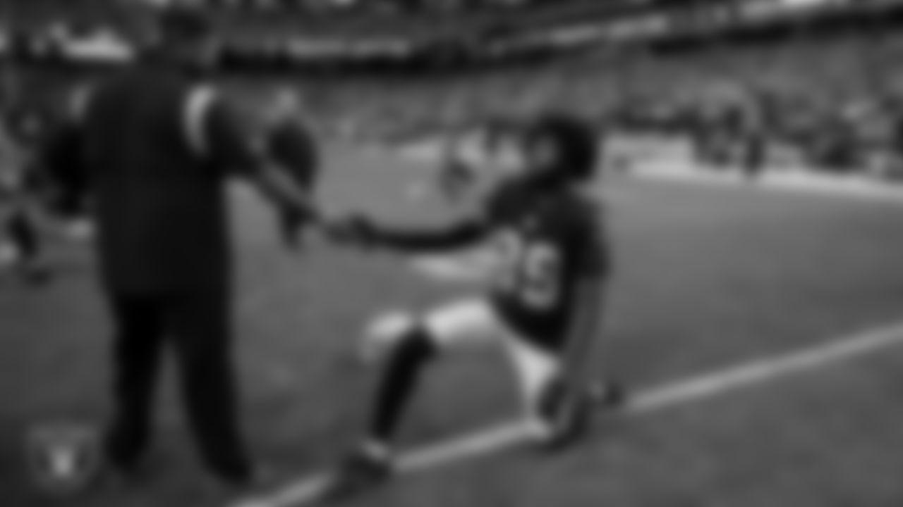 Las Vegas Raiders offensive assistant Taver Johnson and cornerback Nate Hobbs (39) during warm ups before the regular season home game against the Denver Broncos.