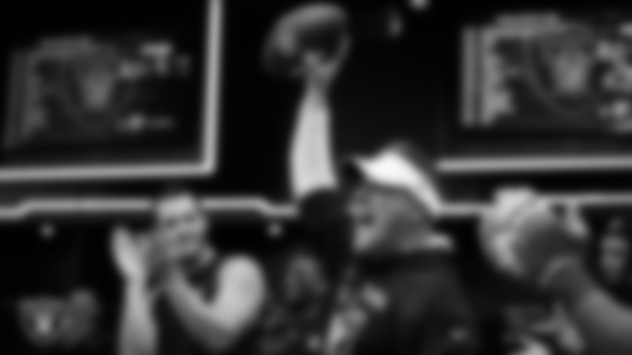 Las Vegas Raiders Head Coach Josh McDaniels celebrates with his players in the locker room after the regular season home game against the Denver Broncos at Allegiant Stadium.